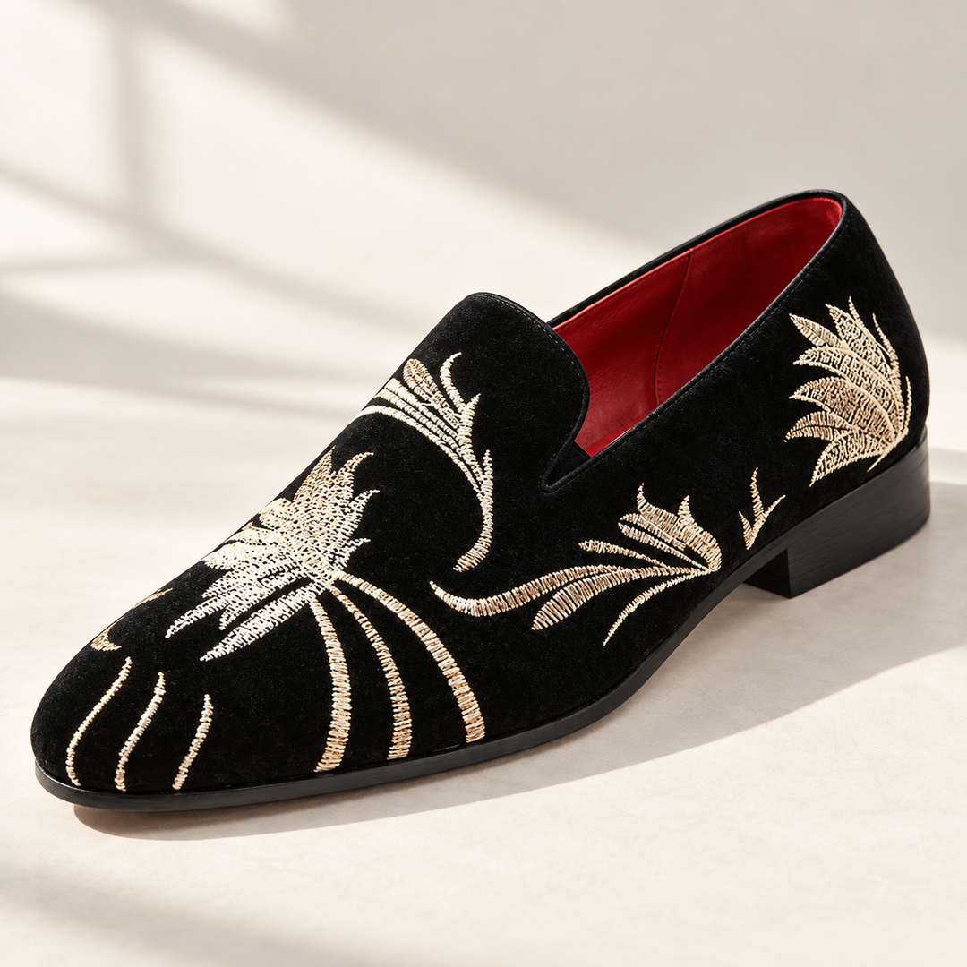 Alessio loafers in black with gold embroidery, studio view.