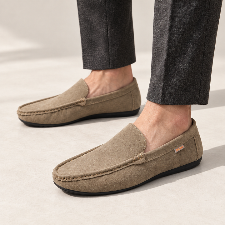 Ellis loafers in khaki, worn with tailored trousers.