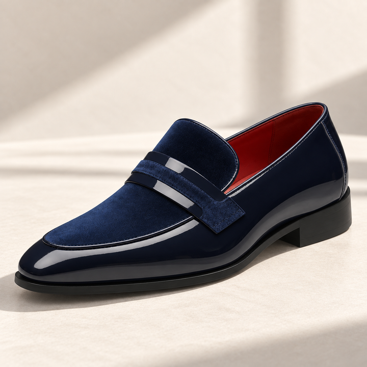 Enzo loafers in navy, photographed on a warm neutral studio background.