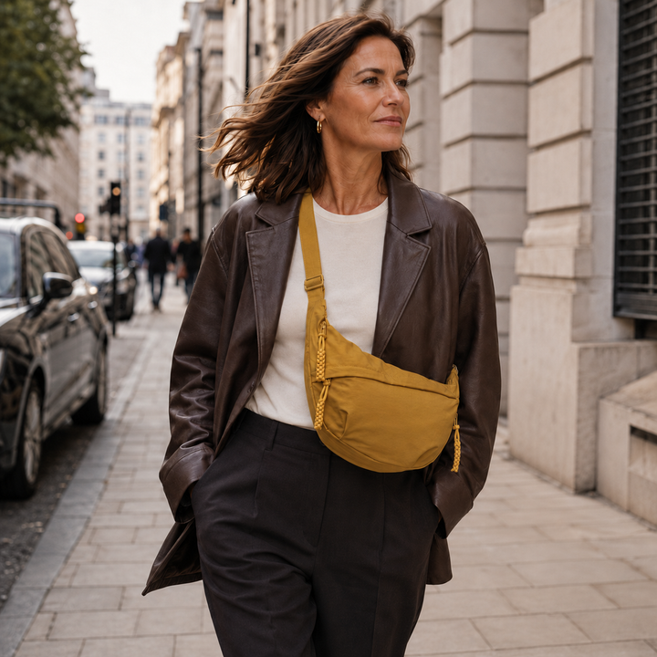 Lucy ochre shoulder bag worn crossbody in the city