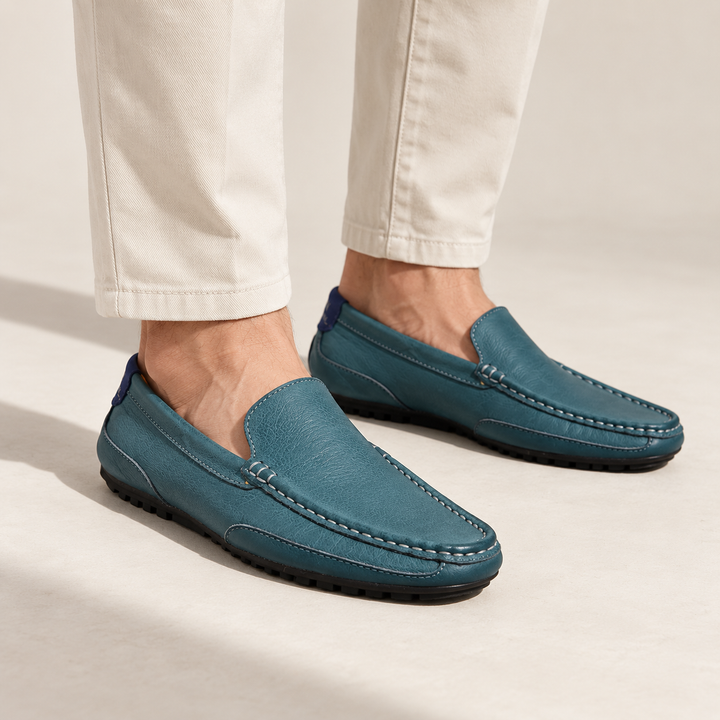 Matteo loafers in petrol blue, worn with tailored trousers.