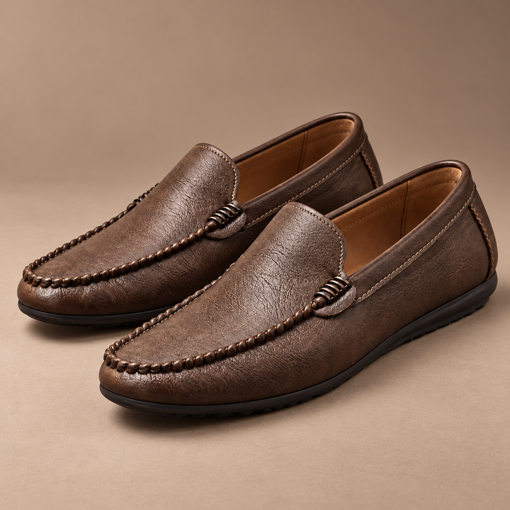 Ronan Genuine Leather Slip-On Loafers in brown, photographed in a warm taupe studio