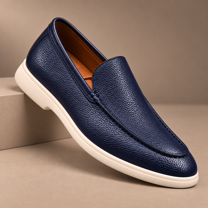 Gianni Genuine Pebbled Leather Loafers in navy, photographed in a warm taupe studio