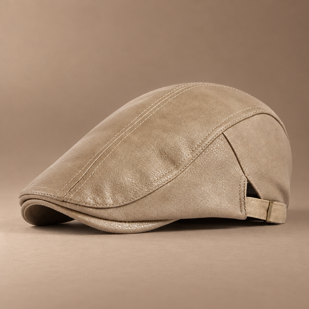 Heritage Leather Driving Cap in beige, photographed in a warm taupe studio