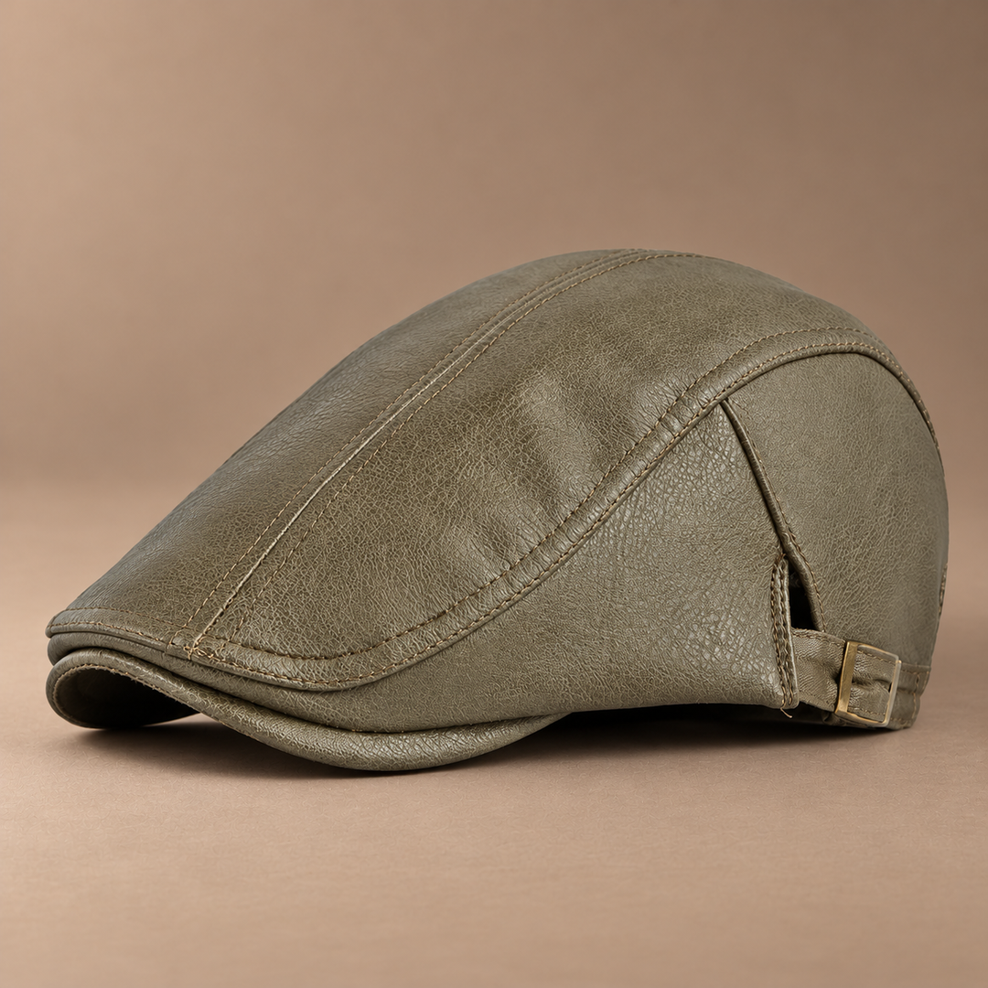 Heritage Leather Driving Cap in army green, photographed in a warm taupe studio