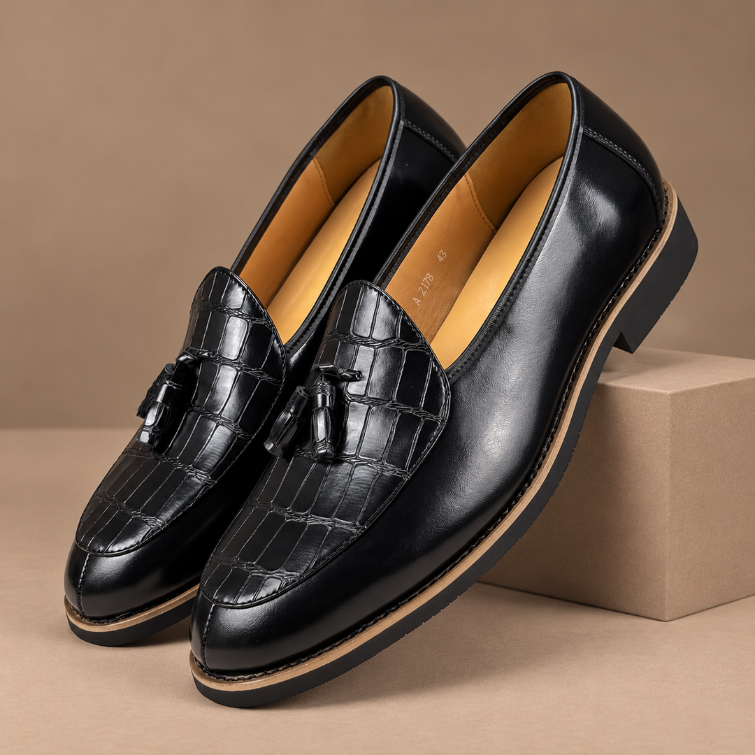 Genuine Leather Tassel Loafers in black, photographed in a warm taupe studio