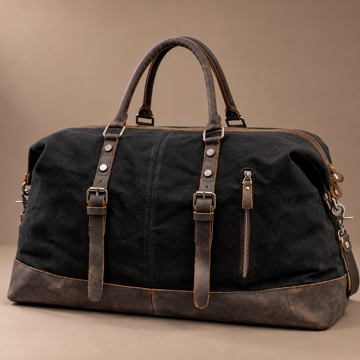 Heinrich Canvas Weekend Bag with Leather Trim in black, photographed in a warm taupe studio