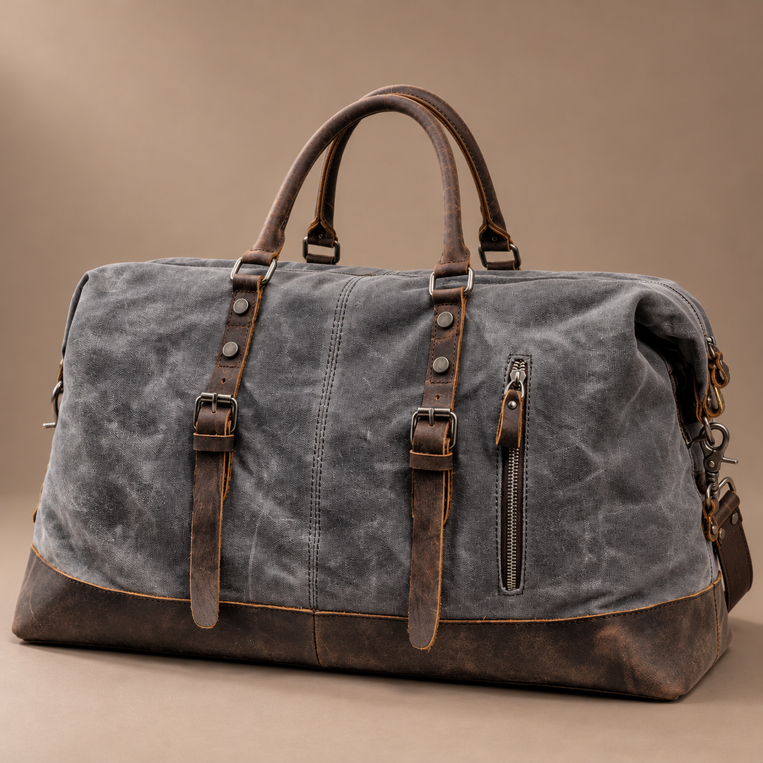 Heinrich Canvas Weekend Bag with Leather Trim in gray, photographed in a warm taupe studio