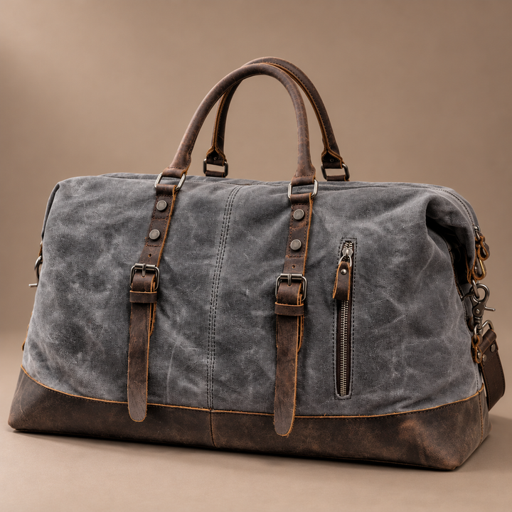 Heinrich Canvas Weekend Bag with Leather Trim in gray, photographed in a warm taupe studio