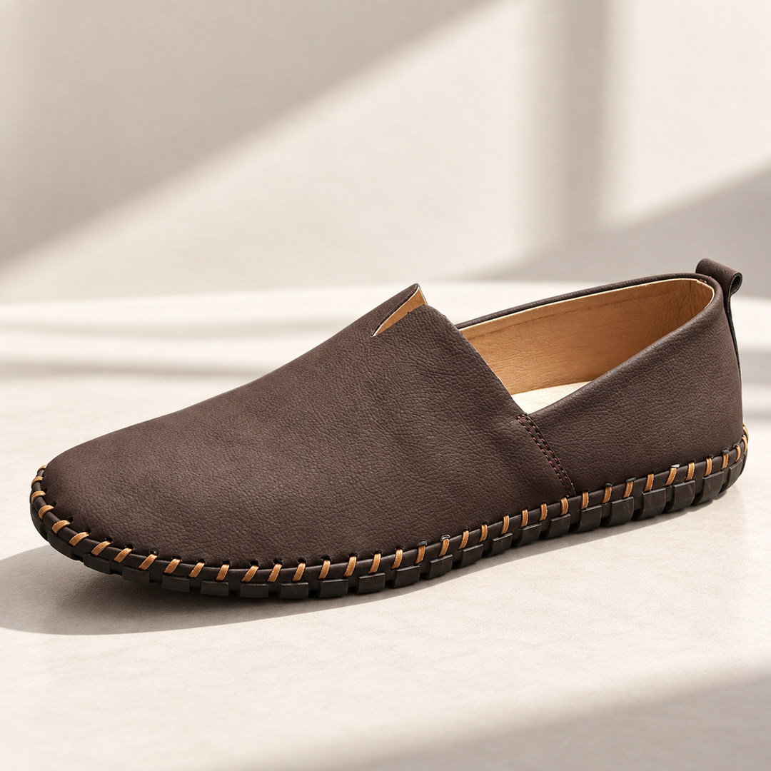 Santorini loafers in dark brown, photographed on a warm neutral studio background.