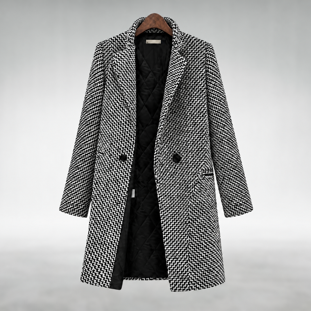 Via black and white patterned long coat on a wooden hanger