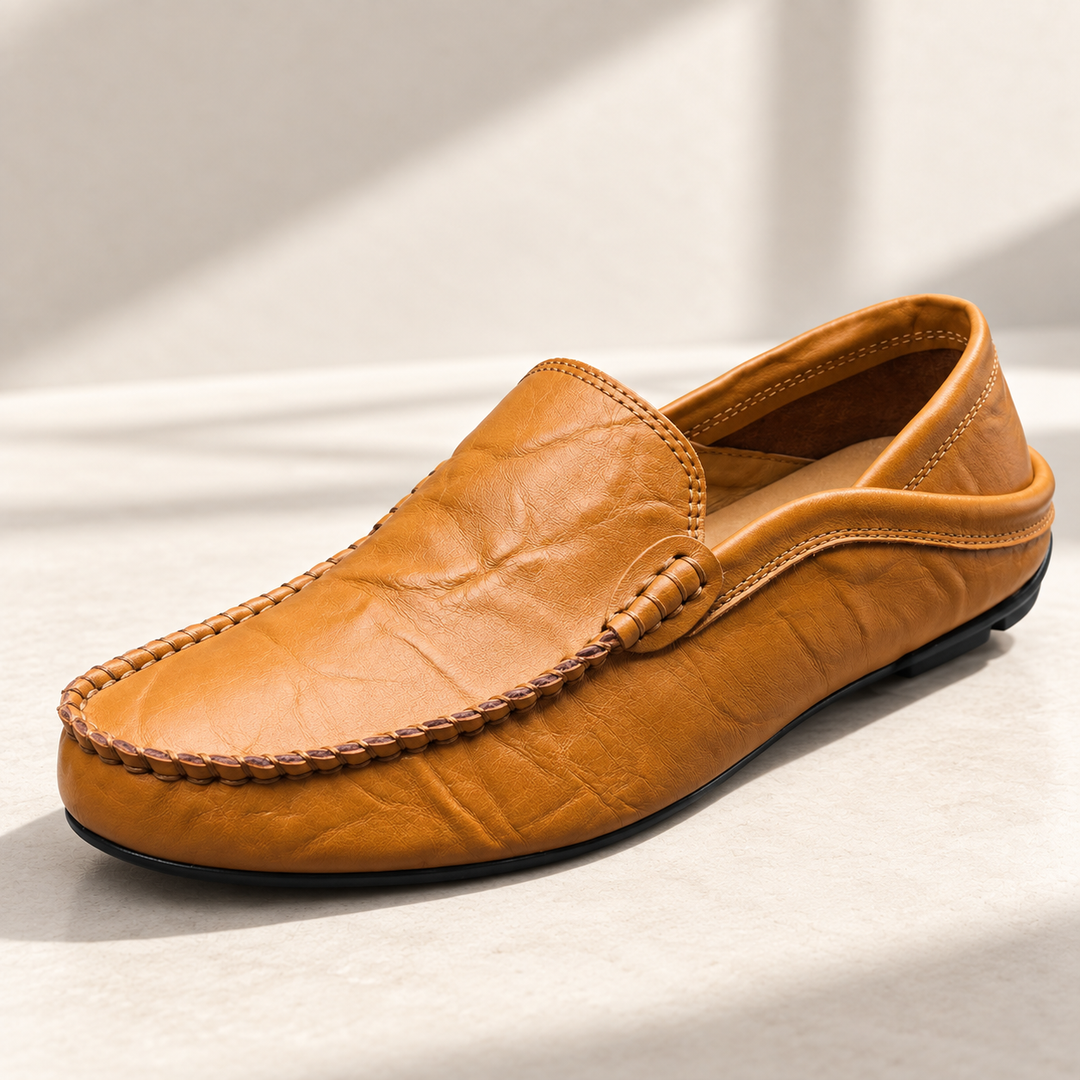 Vittorio loafers in cognac, photographed on a warm neutral studio background.