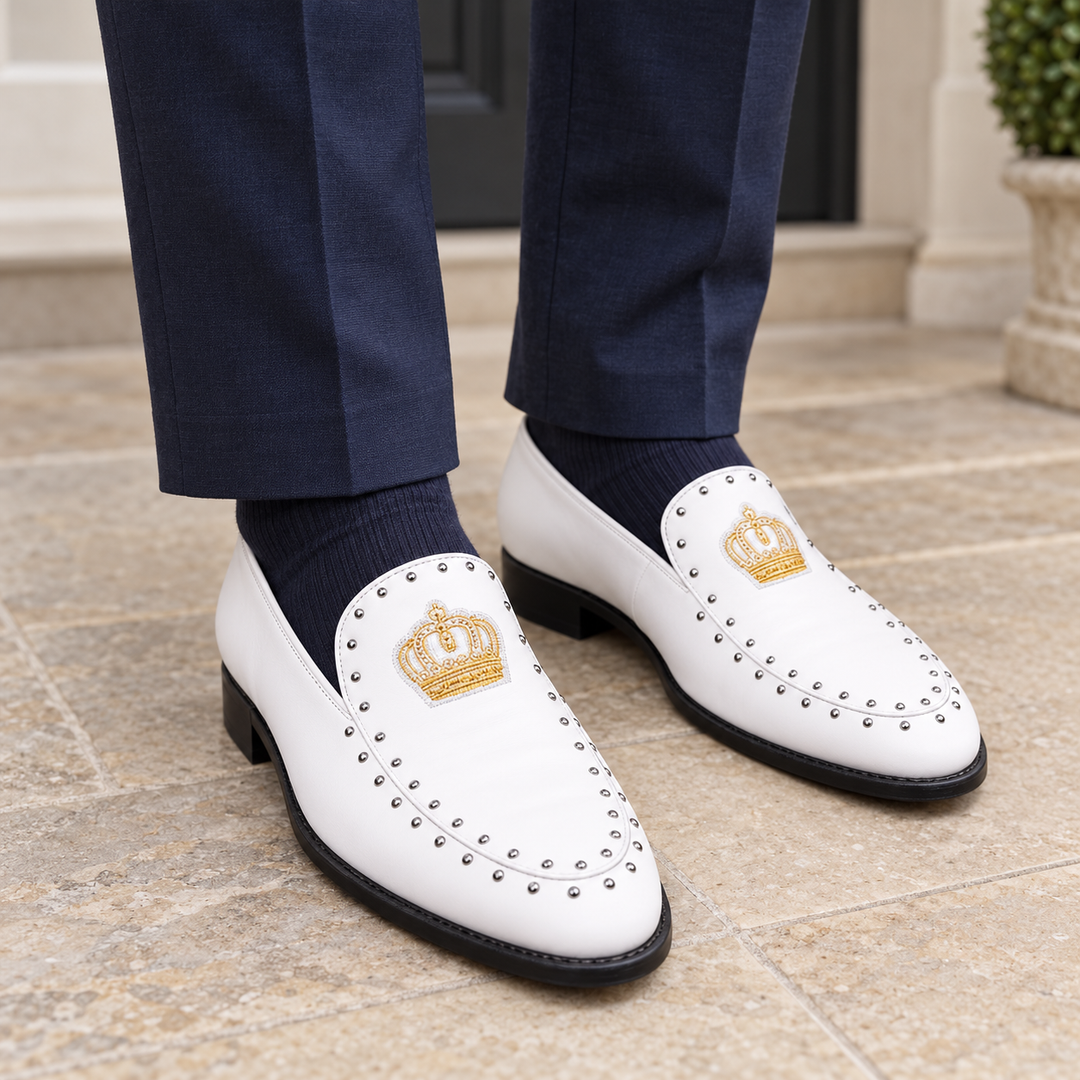 White Winston crown loafers worn with navy tailored trousers